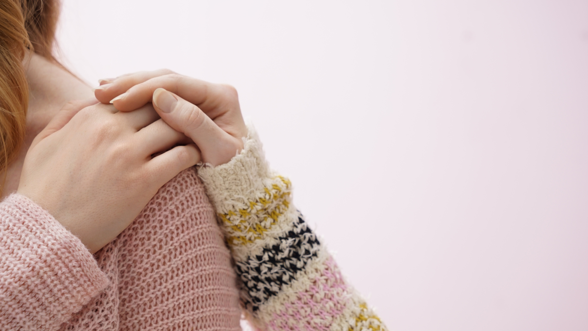 One person showing support to another touching her shoulder